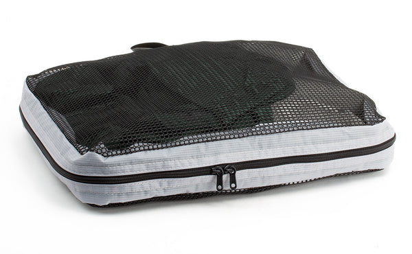 A full, closed Medium Tri-Star Packing Cube in Northwest Sky (light grey) 120 Aether.